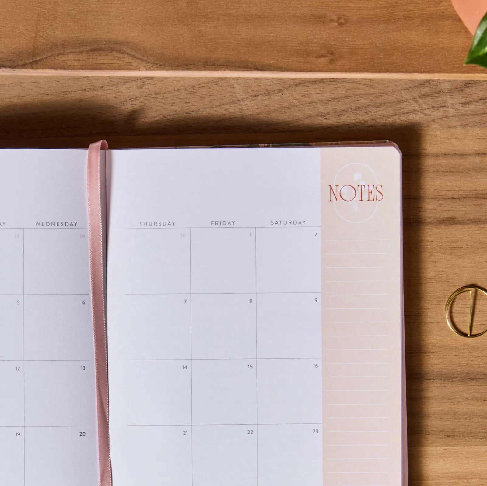 Calendar and notebook on a wooden surface