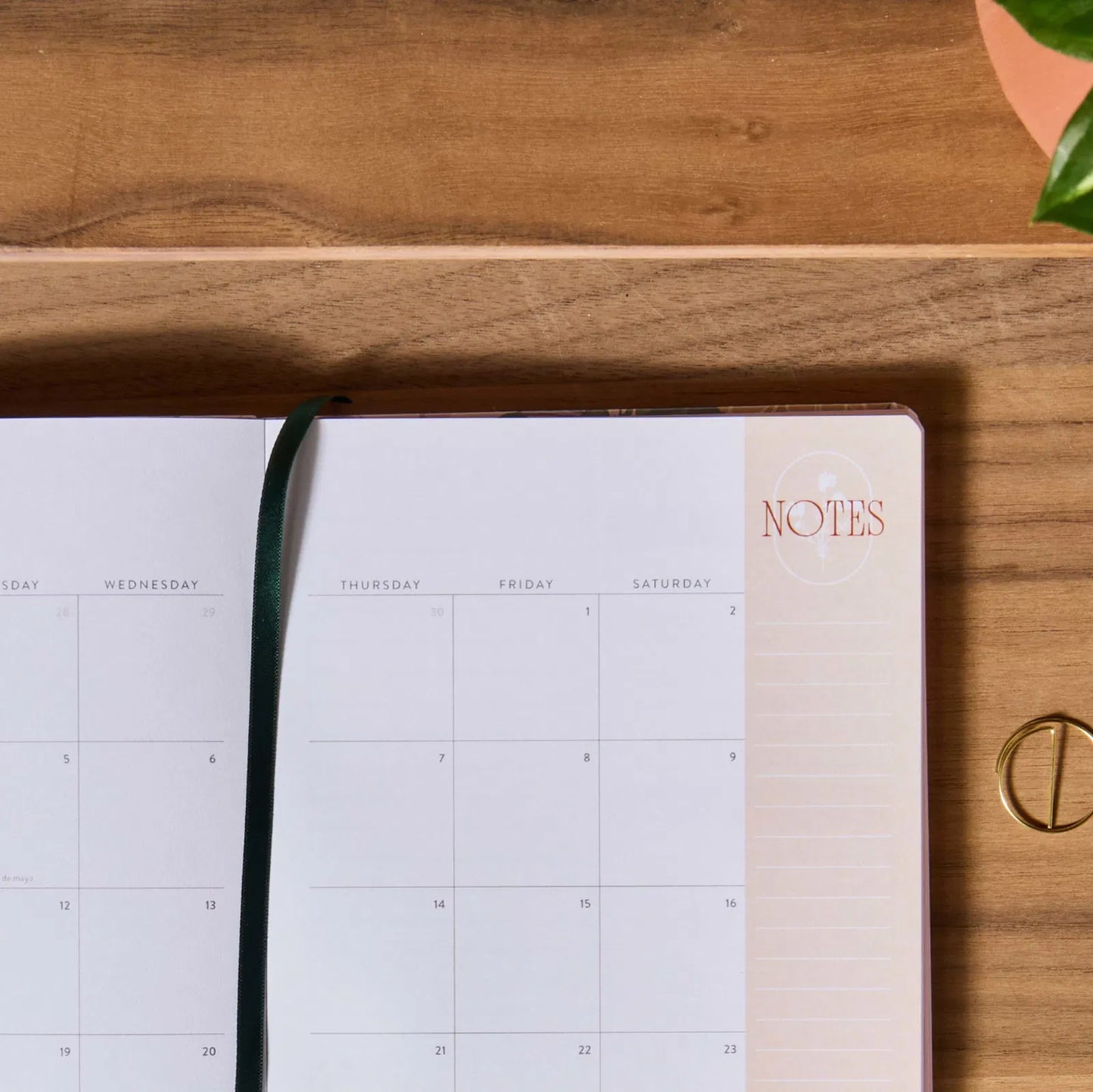 Open planner on a wooden surface with 'NOTES' label