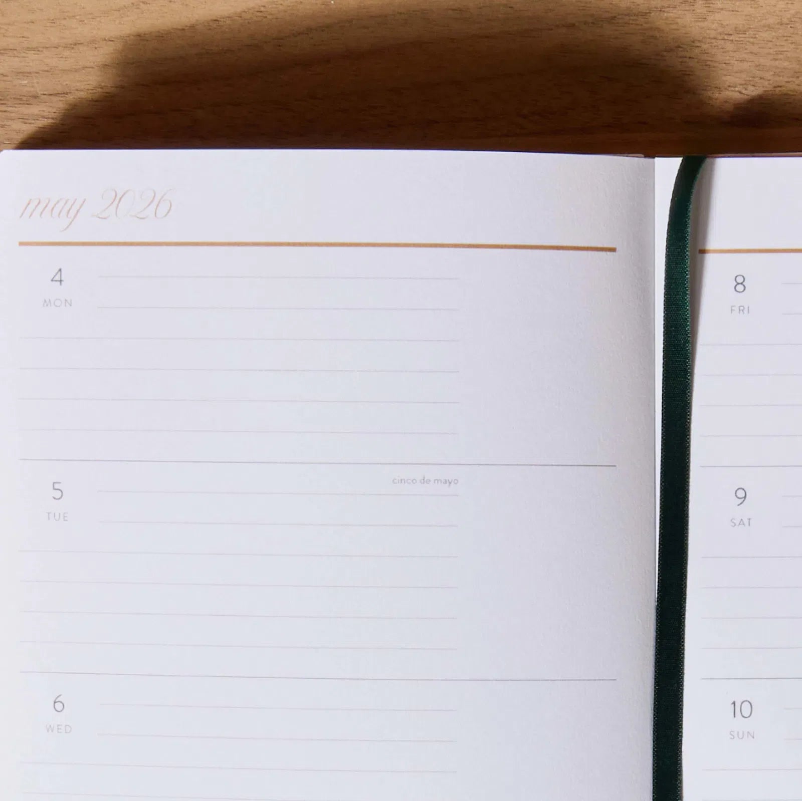 Open planner with a page bookmark, displaying a close-up of the calendar page.