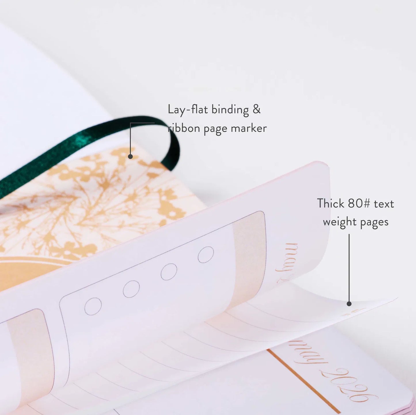 Book with lay-flat binding and ribbon page marker on a white background