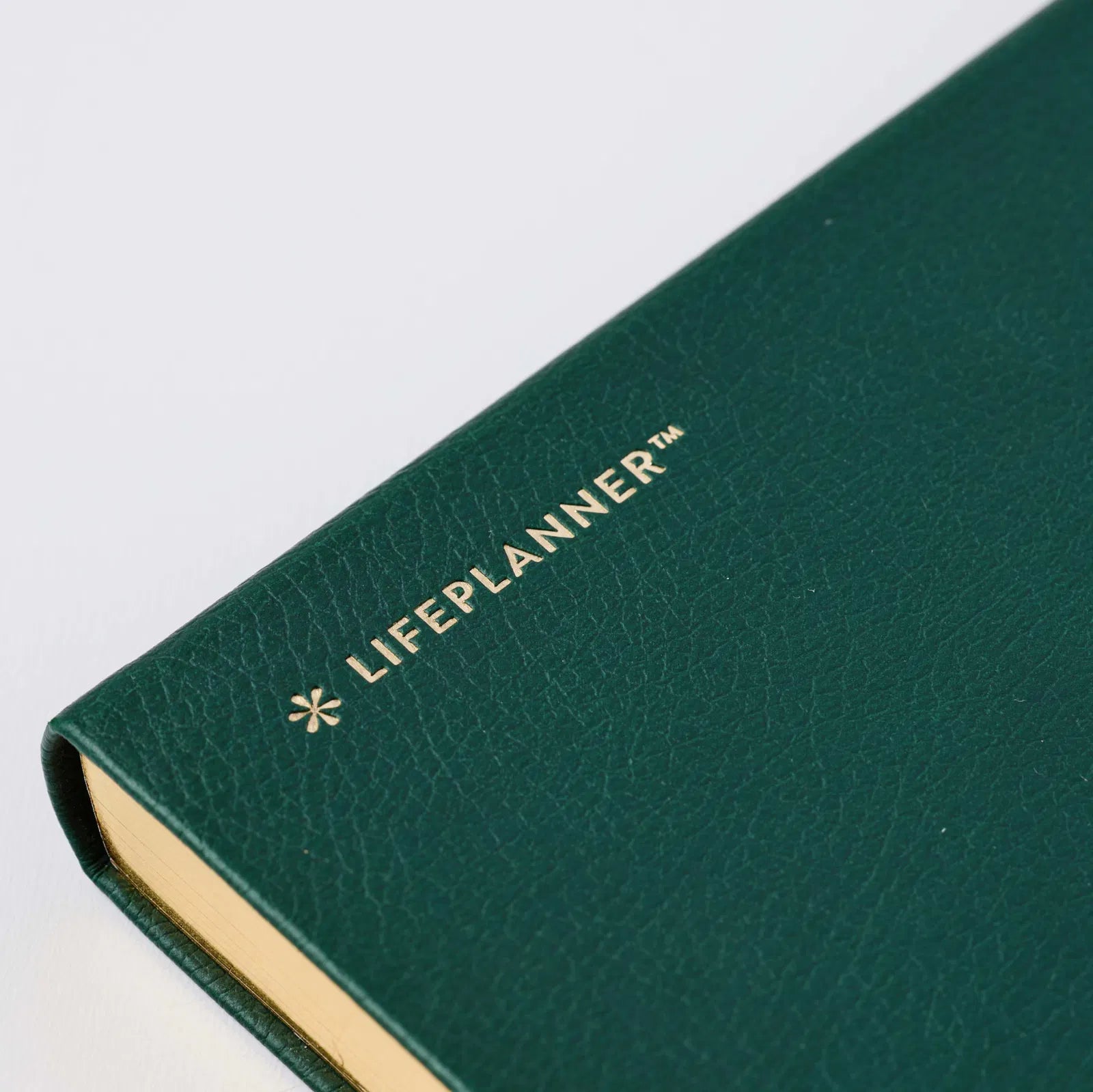 Green planner with 'LIFEPLANNER' branding on a white background