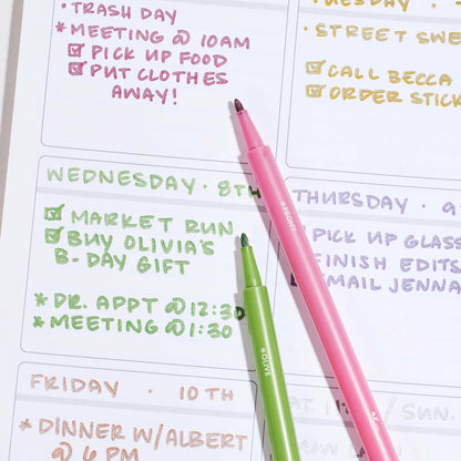 Two highlighters on a planner with daily tasks written out.